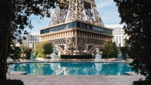 paris hotel pool with eiffel tower and restaurant in the background, during daytime