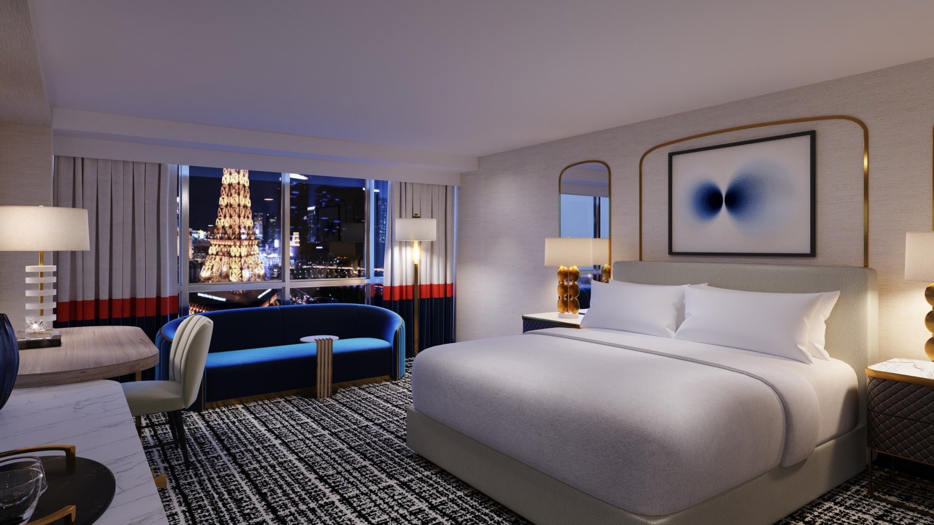 room in paris hotel las vegas with a view of the eiffel tower, bed with couch and desk at night