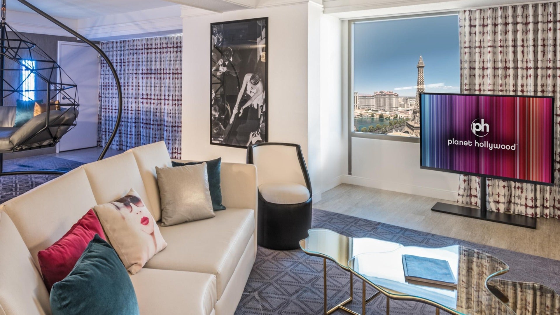 planet hollywood hotel room interior, with tv, couch, painting on the wall and view of paris eiffel tower