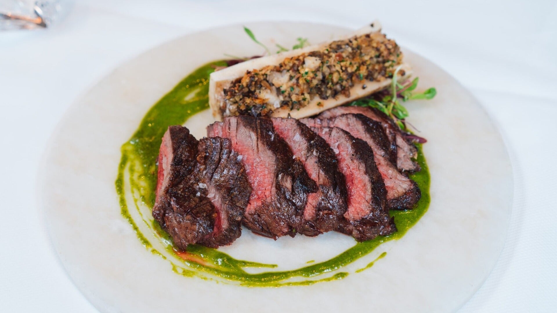 steak served on a plate with bone marrow