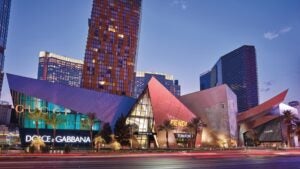 luxury stores at the shops at crystals, gucci, dolce & gabbana, fendi, tom ford, with a building in the back at night