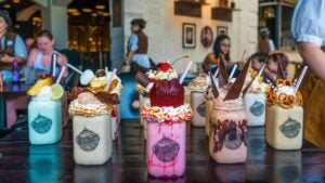 sweet milkshakes with loads of toppings, people at the back