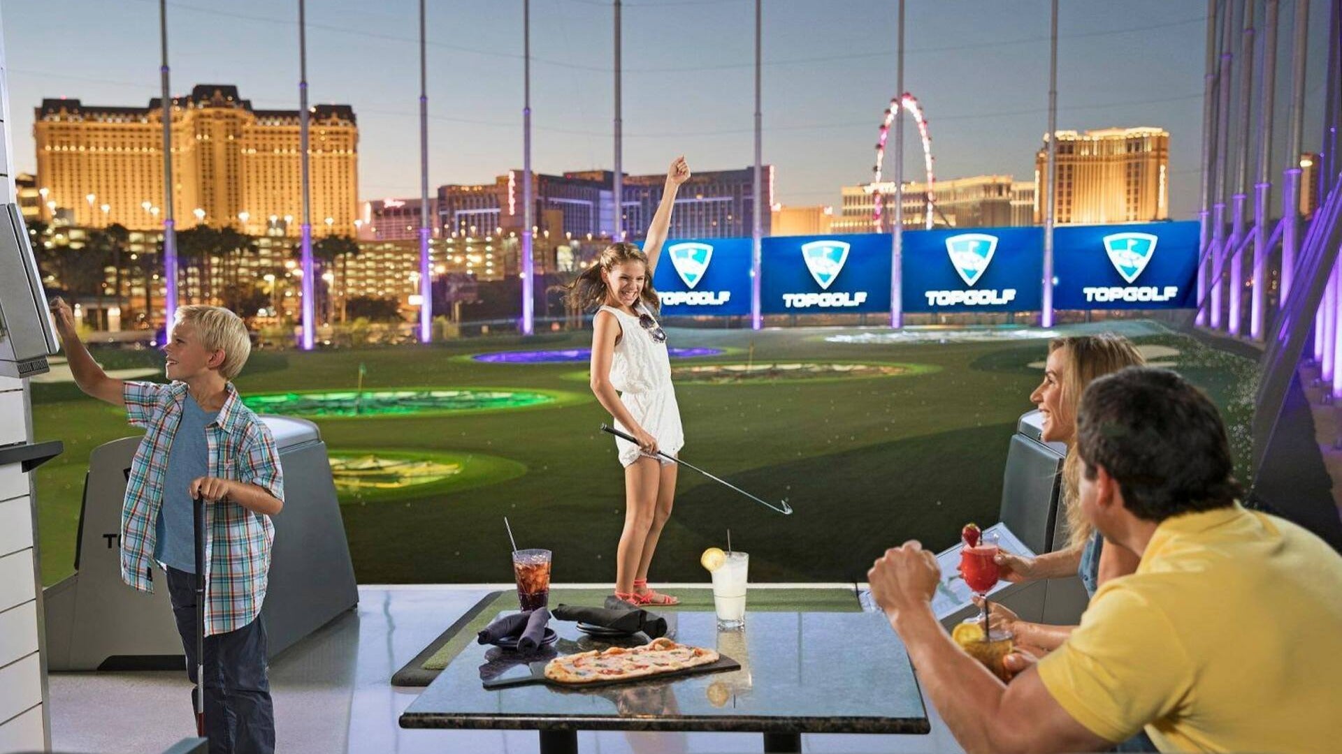 family having dinner, girl playing golf, at a hitting bat with las vegas skyline