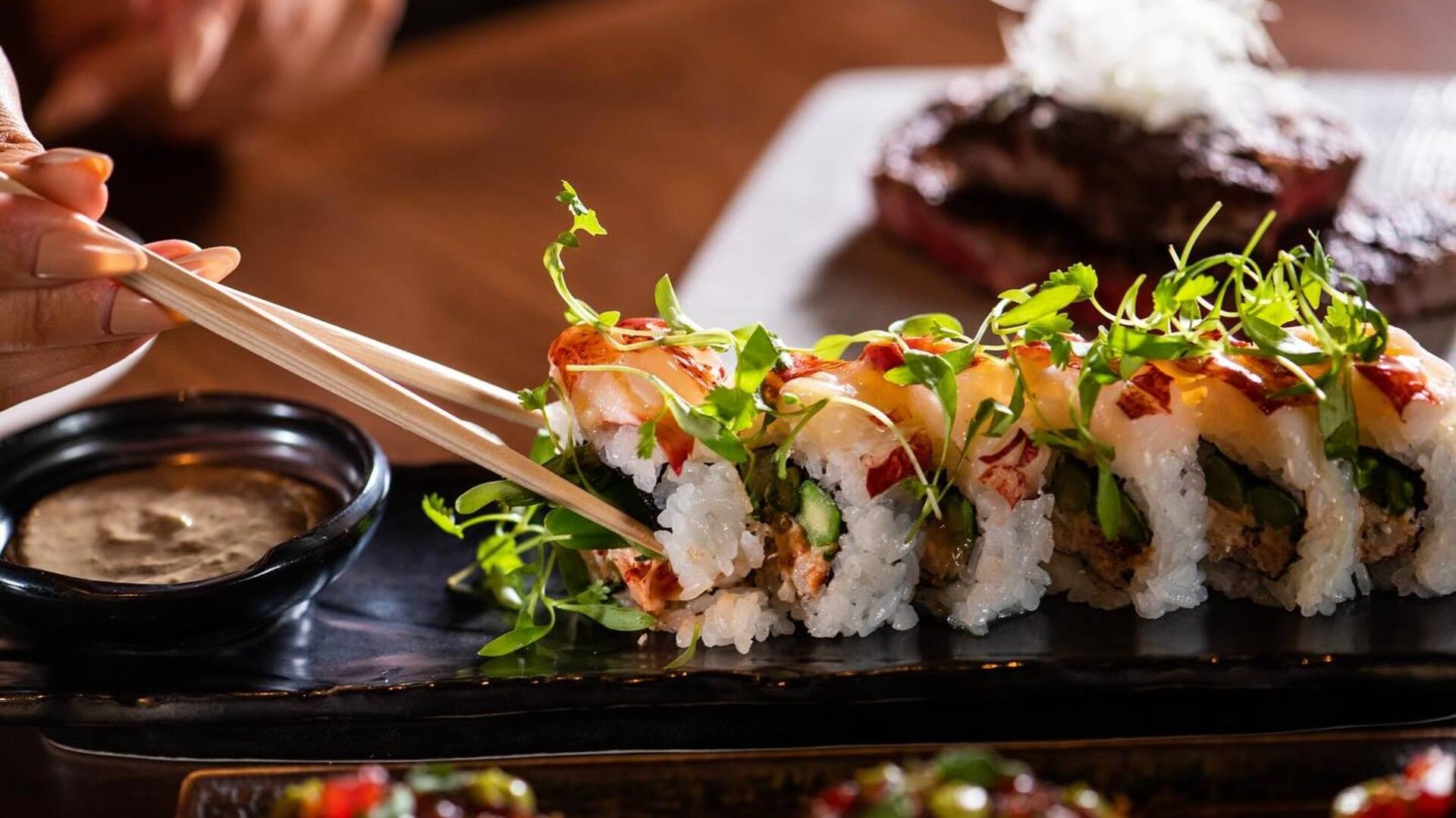 maki or sushi dish with chopsticks and dipping sauce