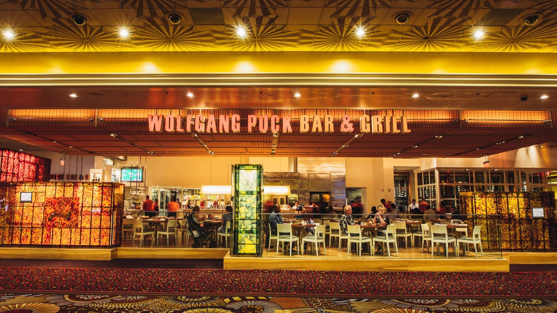 restaurant exterior of Wolfgang Puck Bar & Grill Las Vegas with people dining