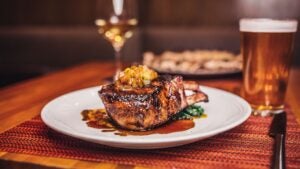 meat with sauce served on a plate at Wolfgang Puck Bar & Grill Las Vegas