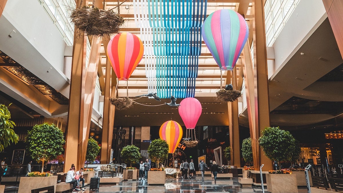 Hotel lobby with fake hot air balloons and greenery