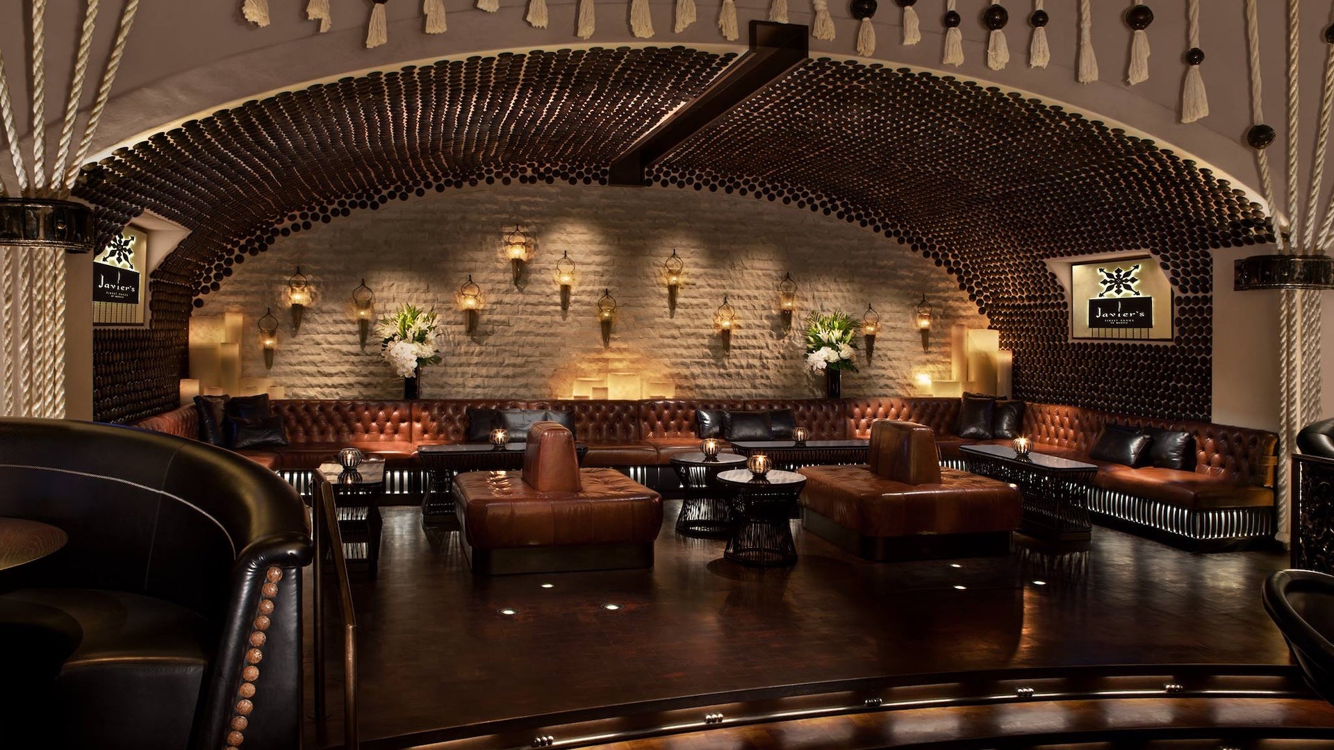 Interior of a restaurant with leather seating and a stone archway