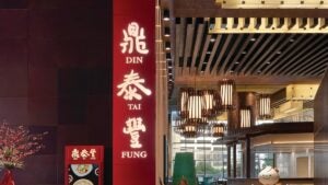 Entrance to a restaurant with a red sign that says Din Tai Fung