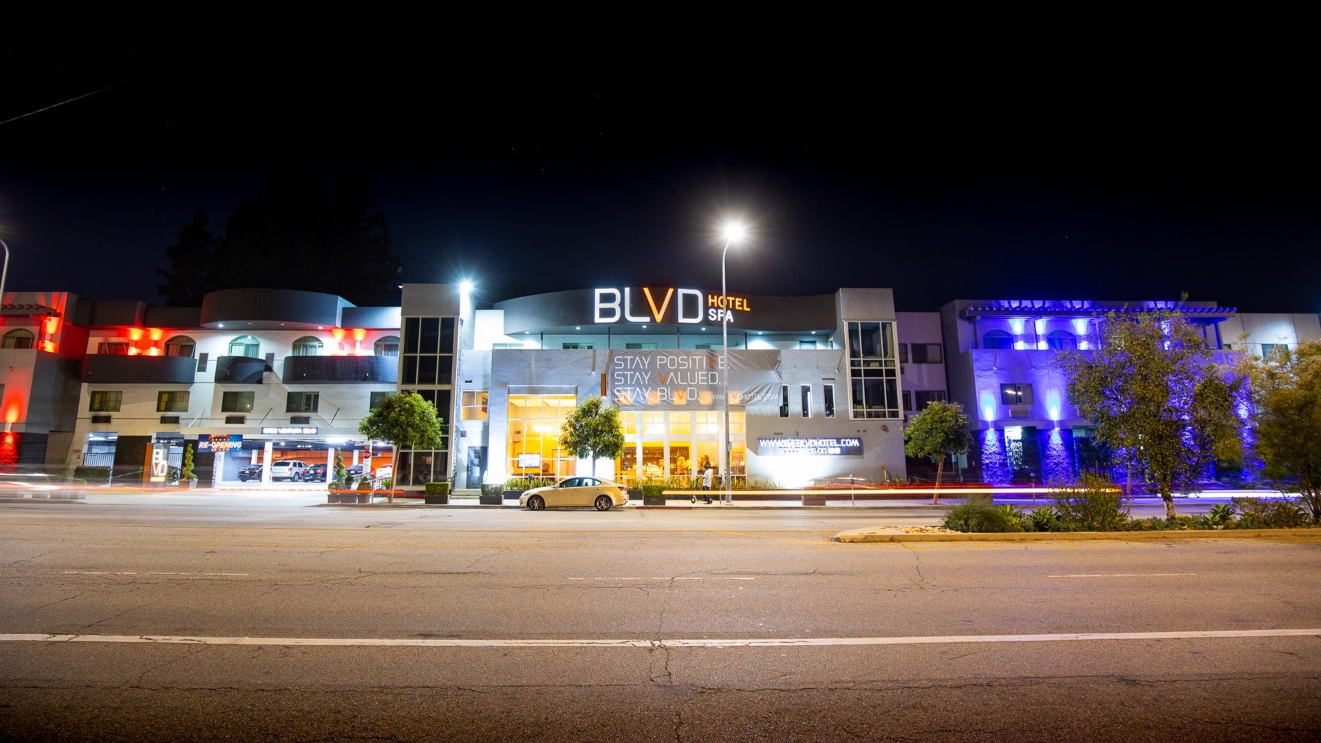 hotel exterior along a street with a street lamp in front and buildings on the side