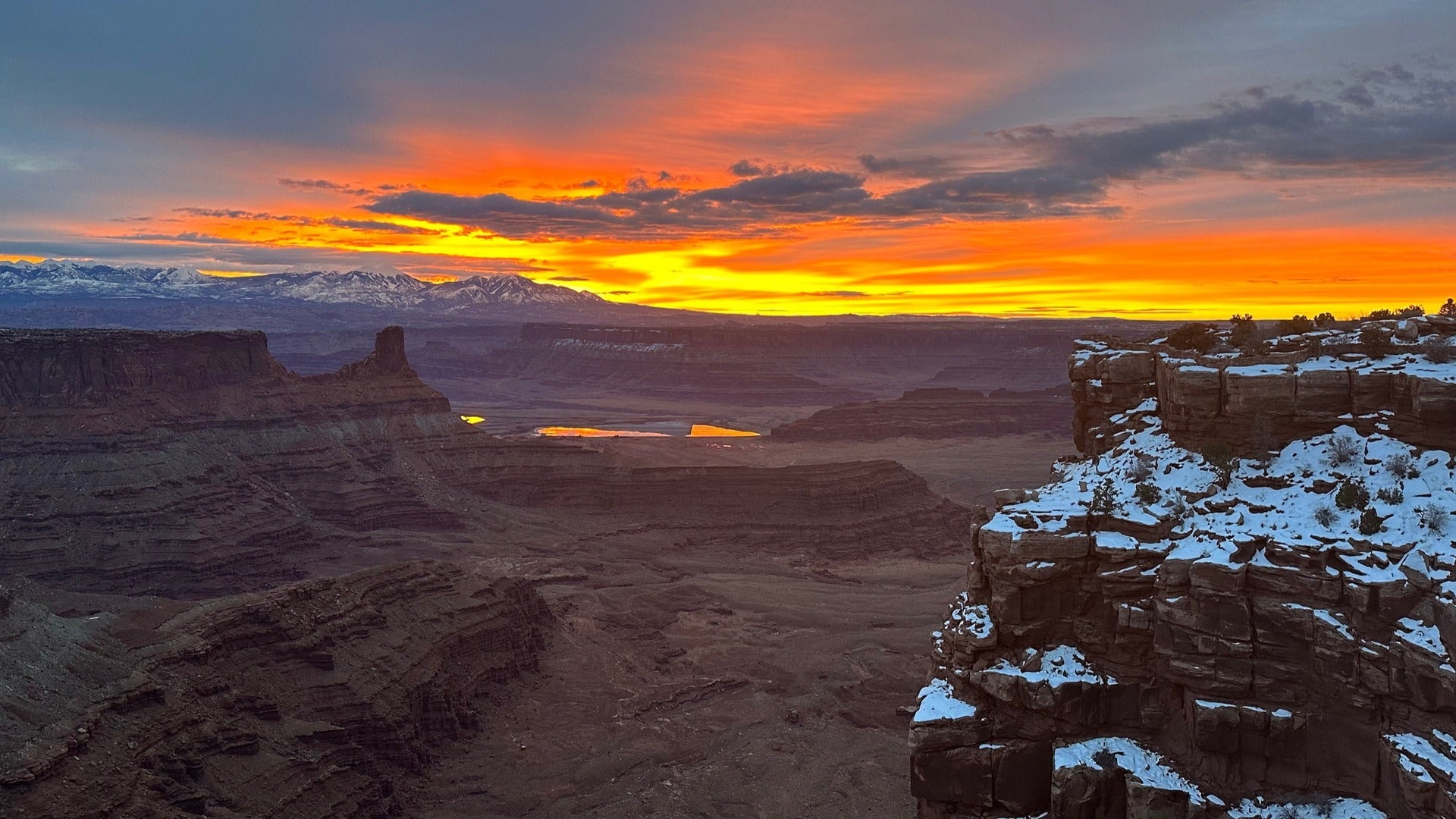 sunrise over mountains, snow on top of rocks