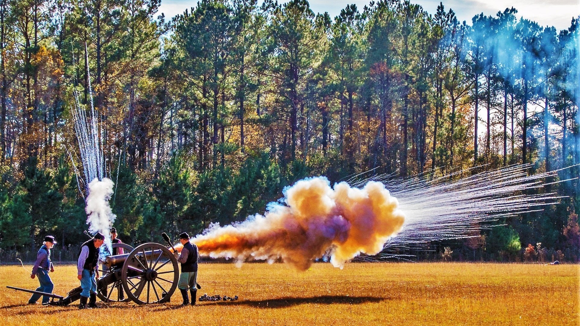 four men with an old explosive device