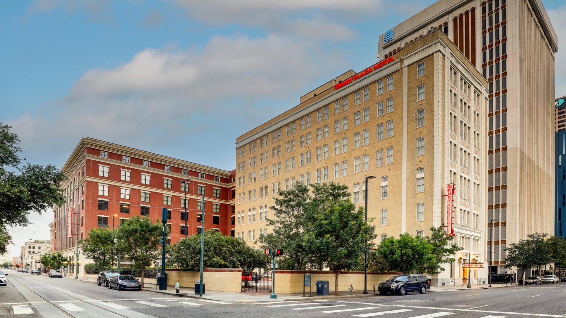 hotel exterior along the street with cars and buildings