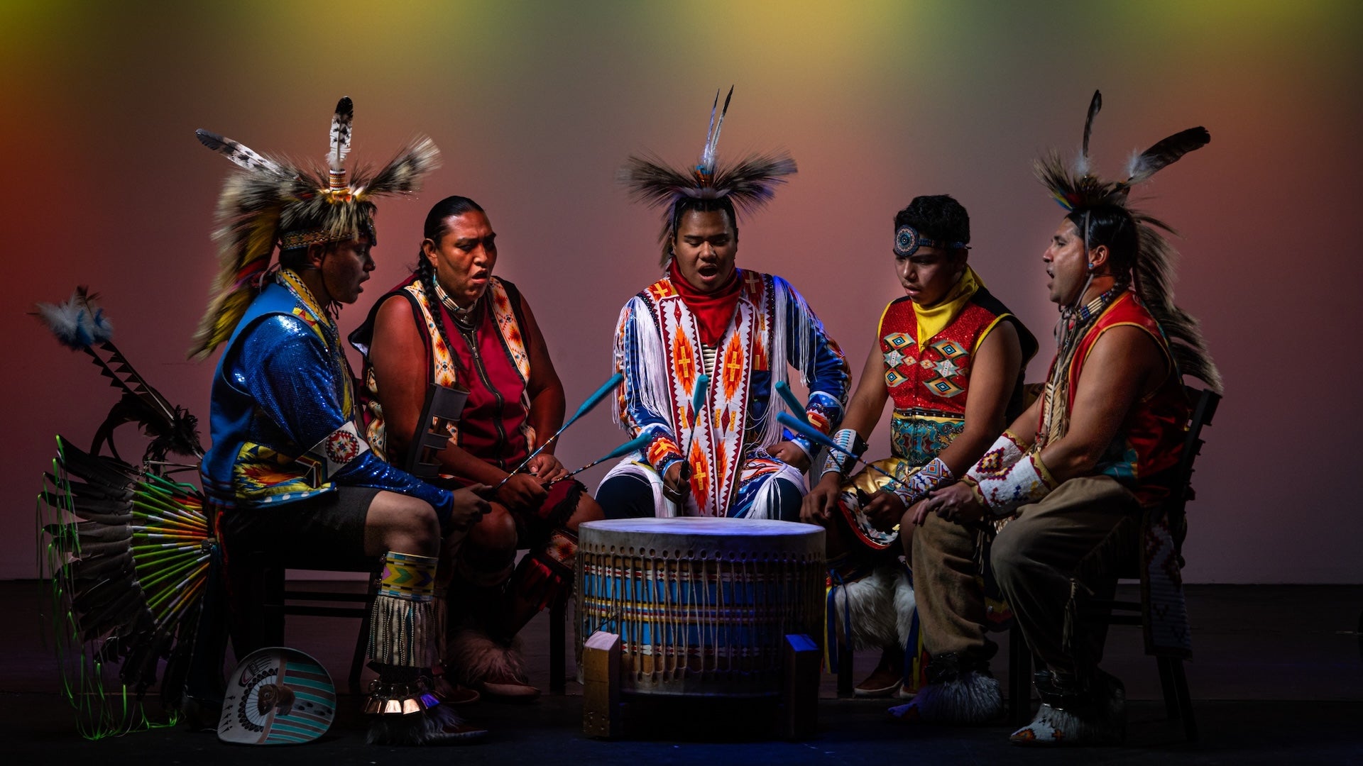 a group of indigenous men sitting