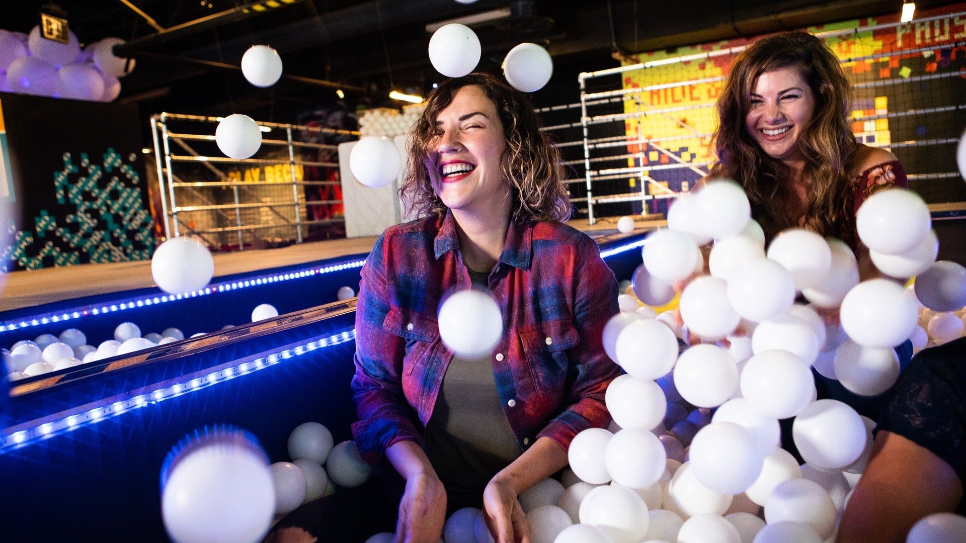 women playing in a ballpit