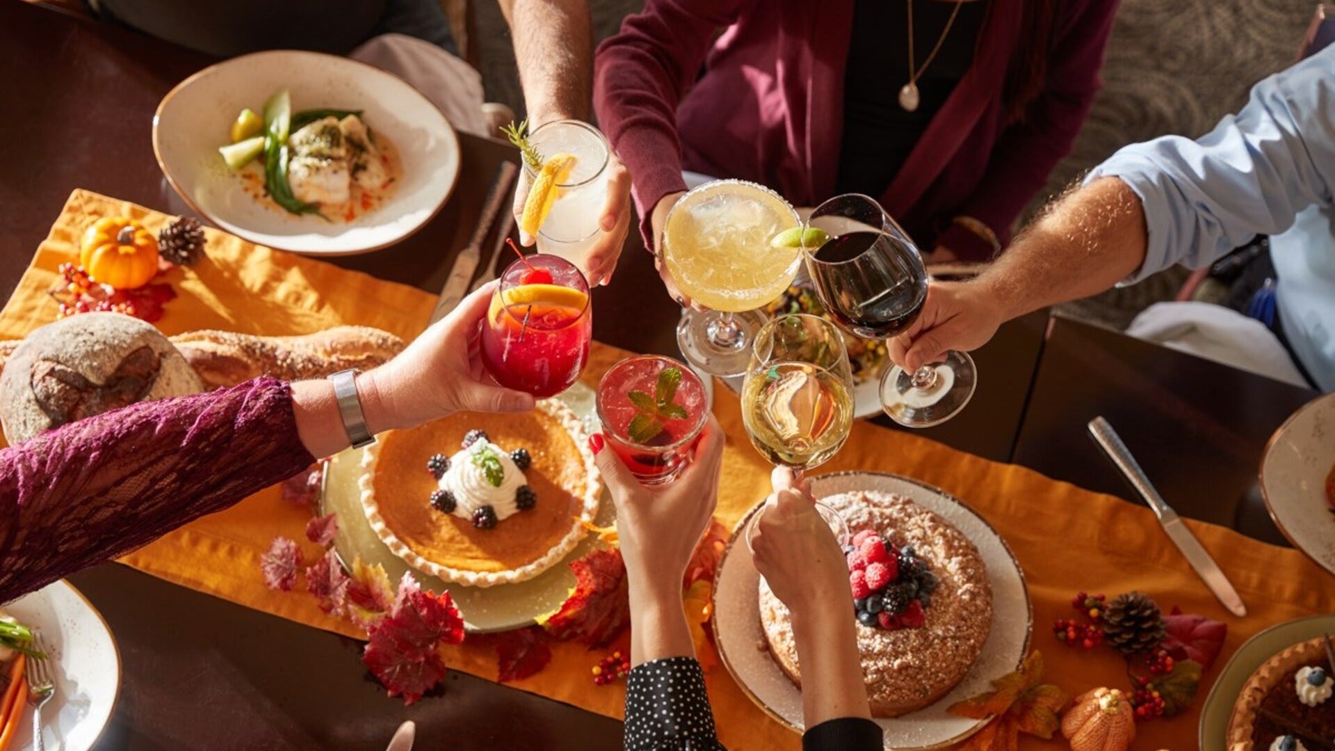 people toasting over desserts and food