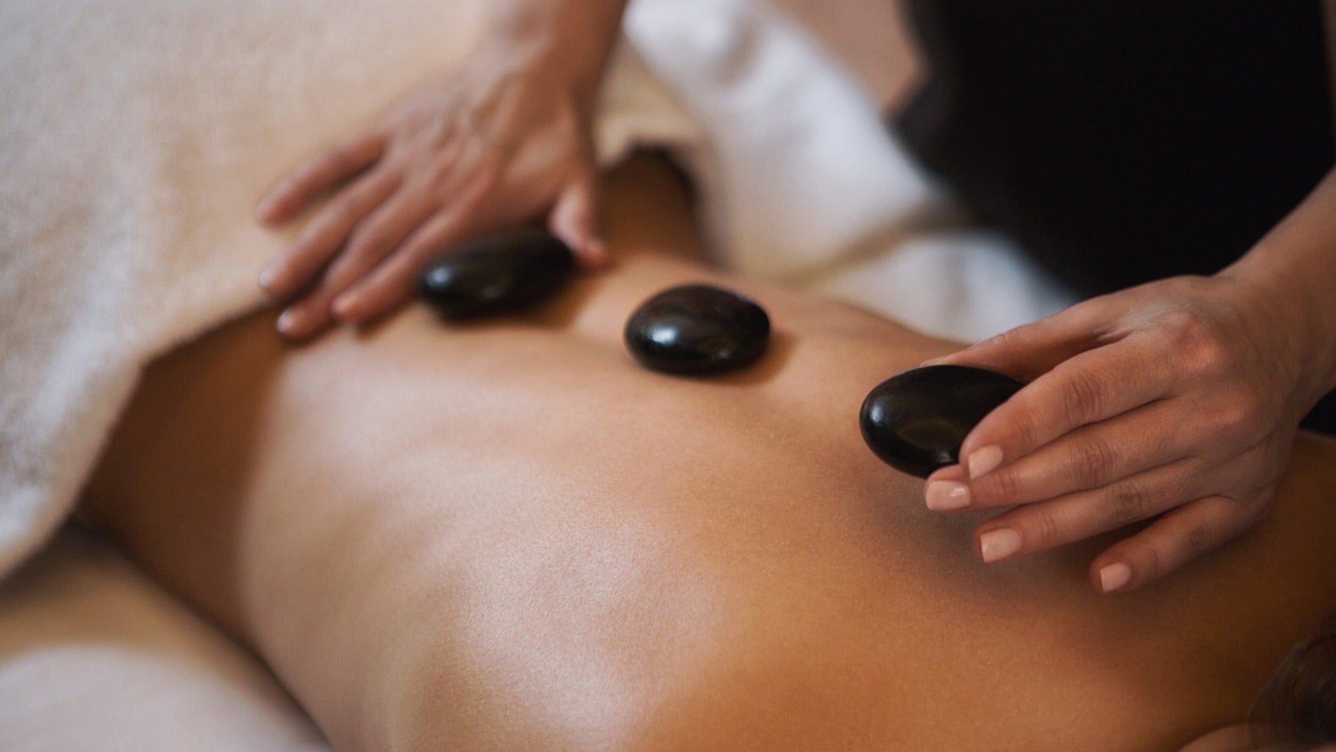 hot stone massage on a client