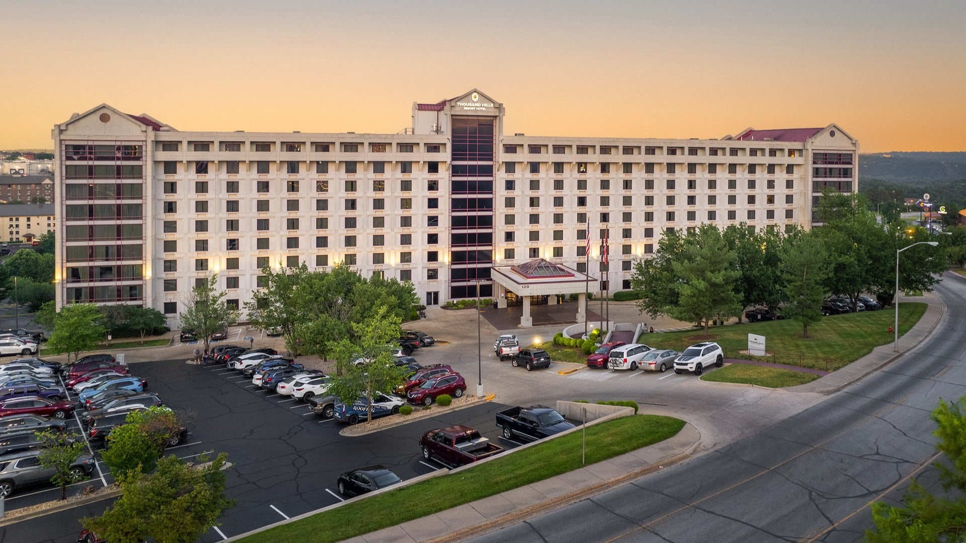 hotel exterior with parking and cars in front