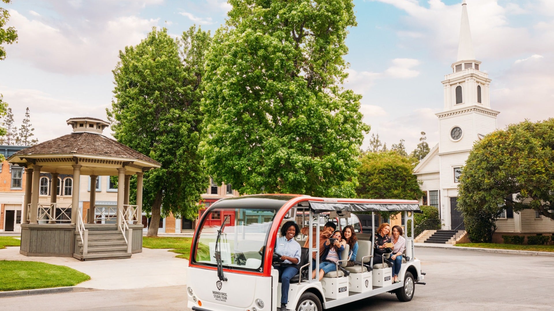 group of people in a tour around warner brother hollywood, stars hollow set