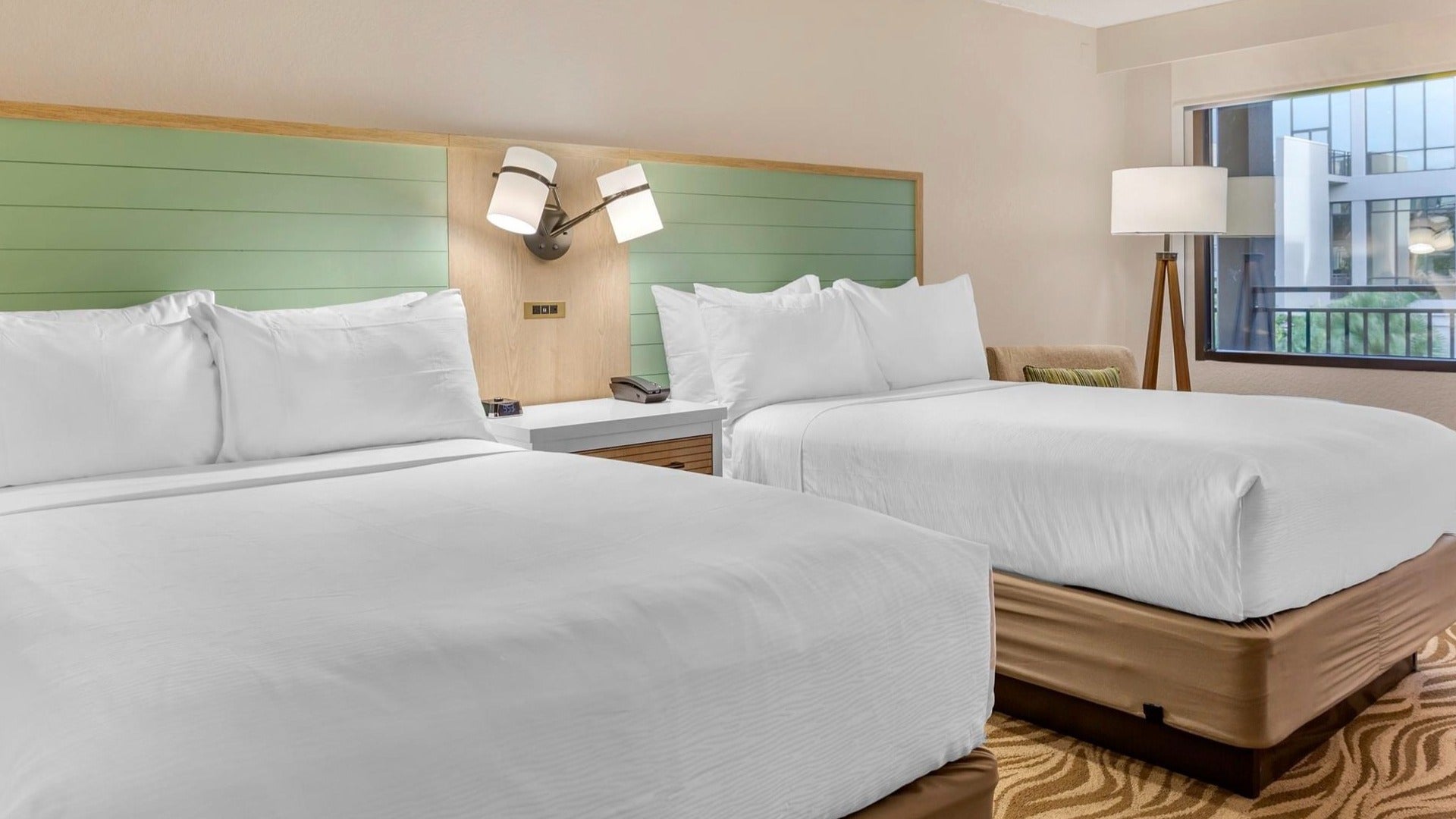 beds with lamps and window on the side, hotel room interior