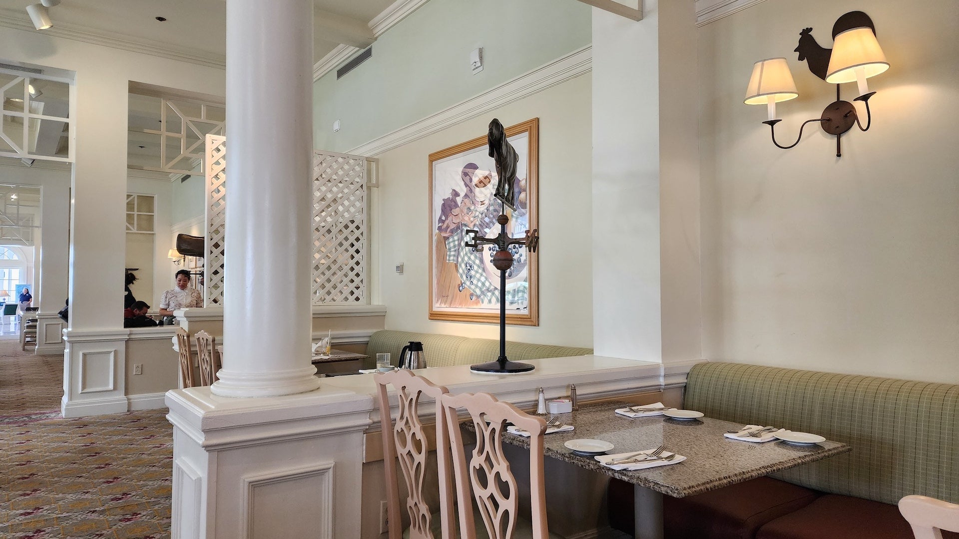 Interior of a restaurant with cream walls, granite tables, and upscale farmhouse decor