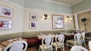 Interior of a restaurant with cream walls, granite tables, and upscale farmhouse decor