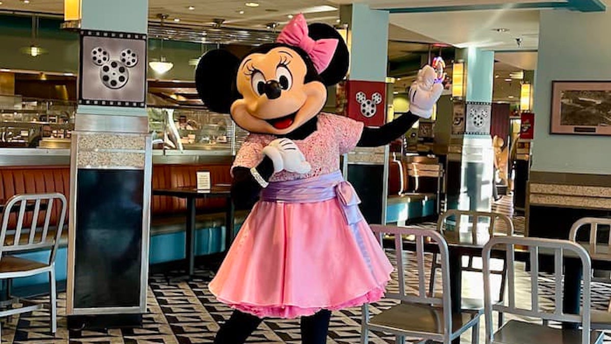 Minnie Mouse in a pink dress at a 50s style diner