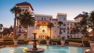 hotel exterior with trees and fountain in front