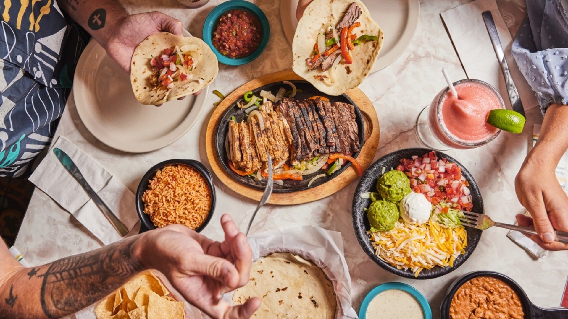 people eating mexican food on a table