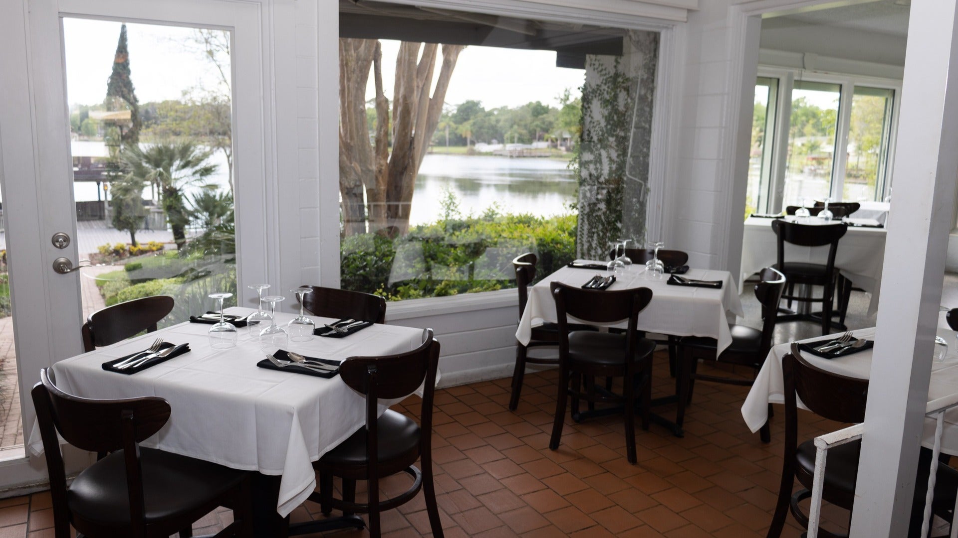 fine dining tables and chairs with a view of the lake