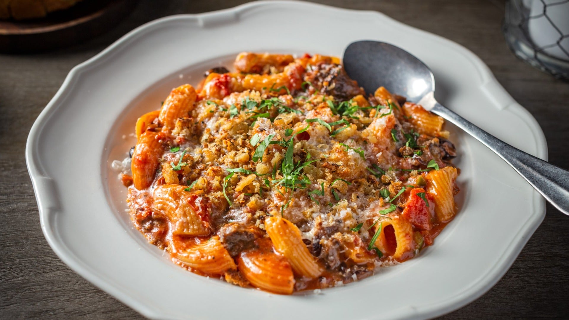 pasta dish served on a plate with a spoon