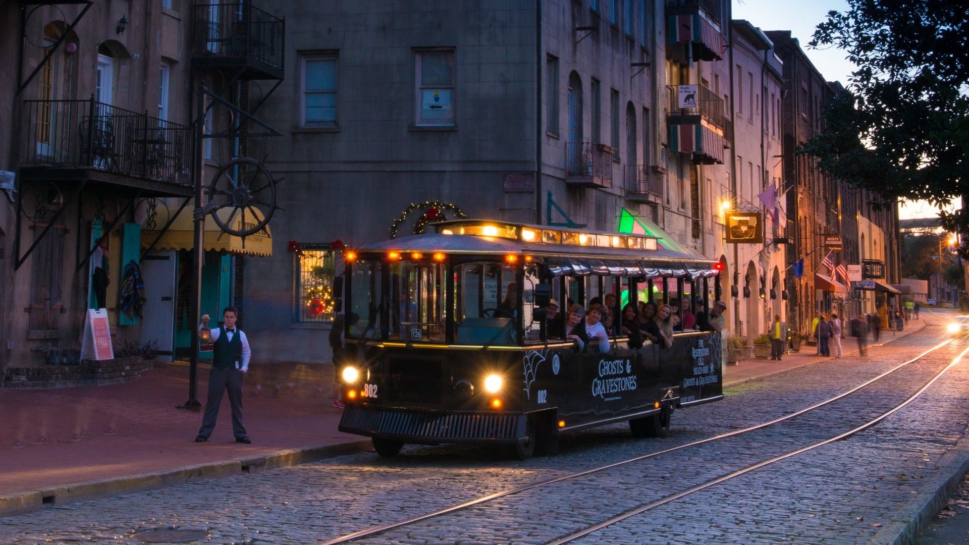 people riding a tour bus along the road