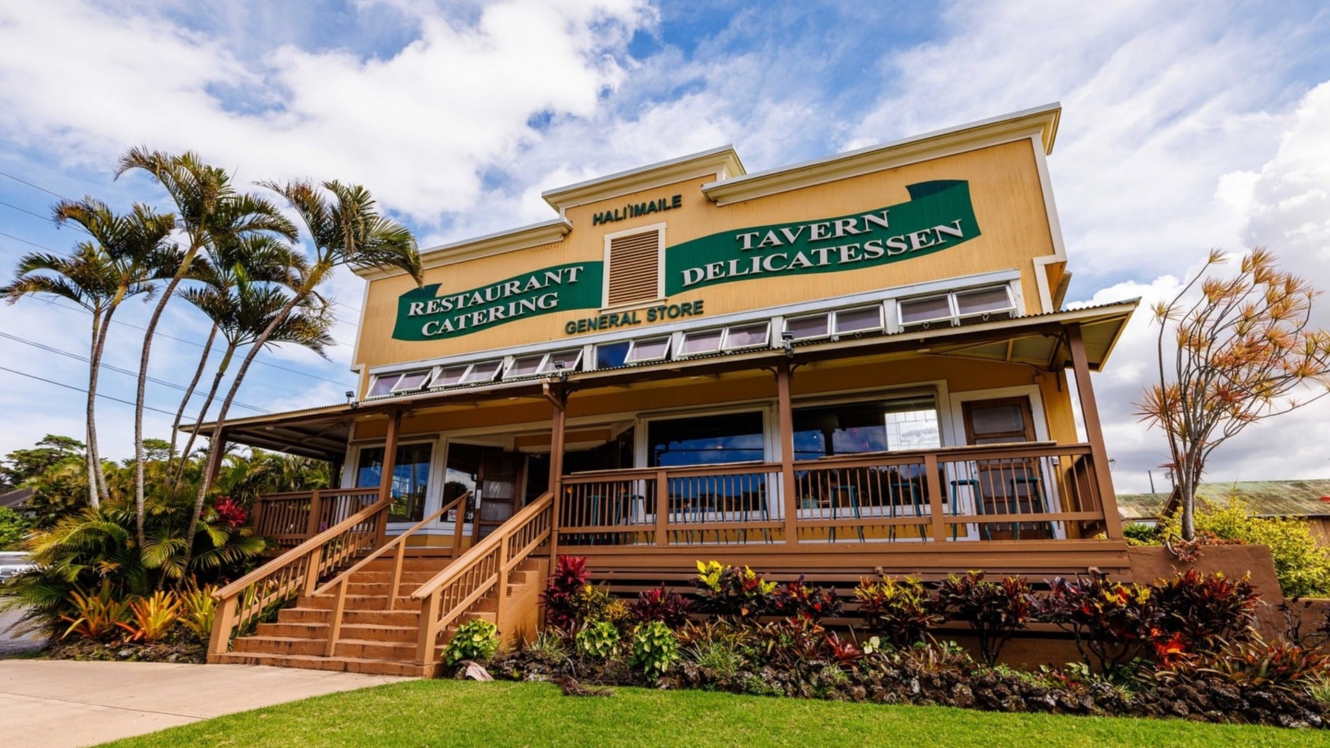 restaurant exterior with trees and plants in front