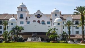 hotel exterior with trees in front and a fountain