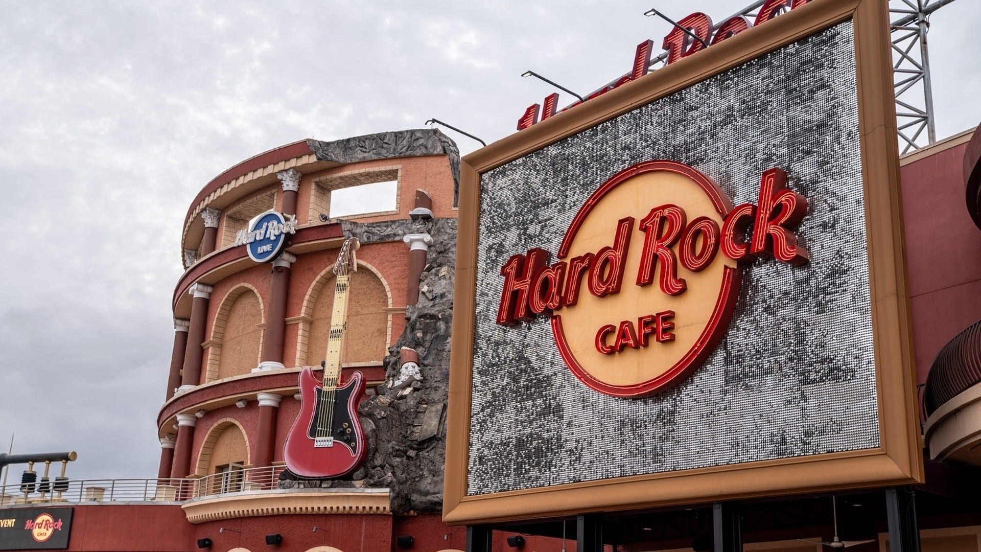 restaurant exterior with big signage and guitar display