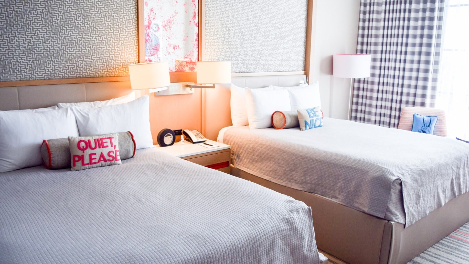 hotel beds with lamp and curtain at the side