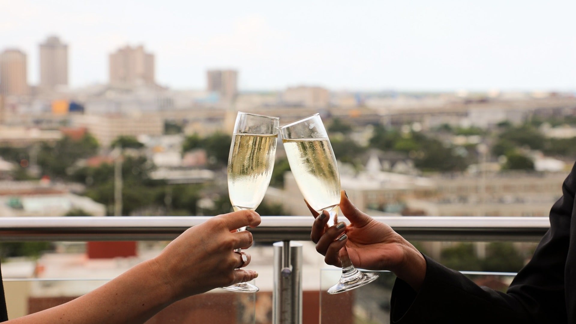 couple toasting with champagne and a view at the back