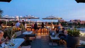 people enjoying drinks on a rooftop bar