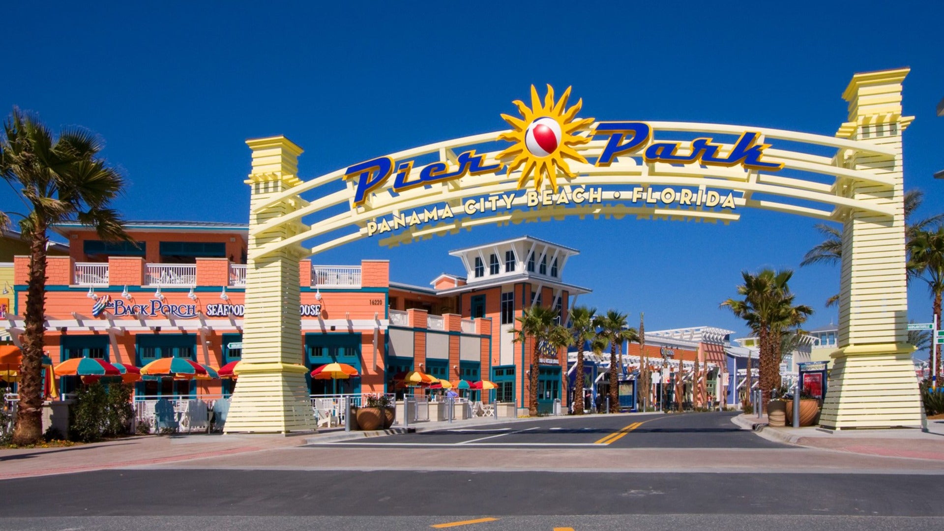 pier park signage with a street lined with shops