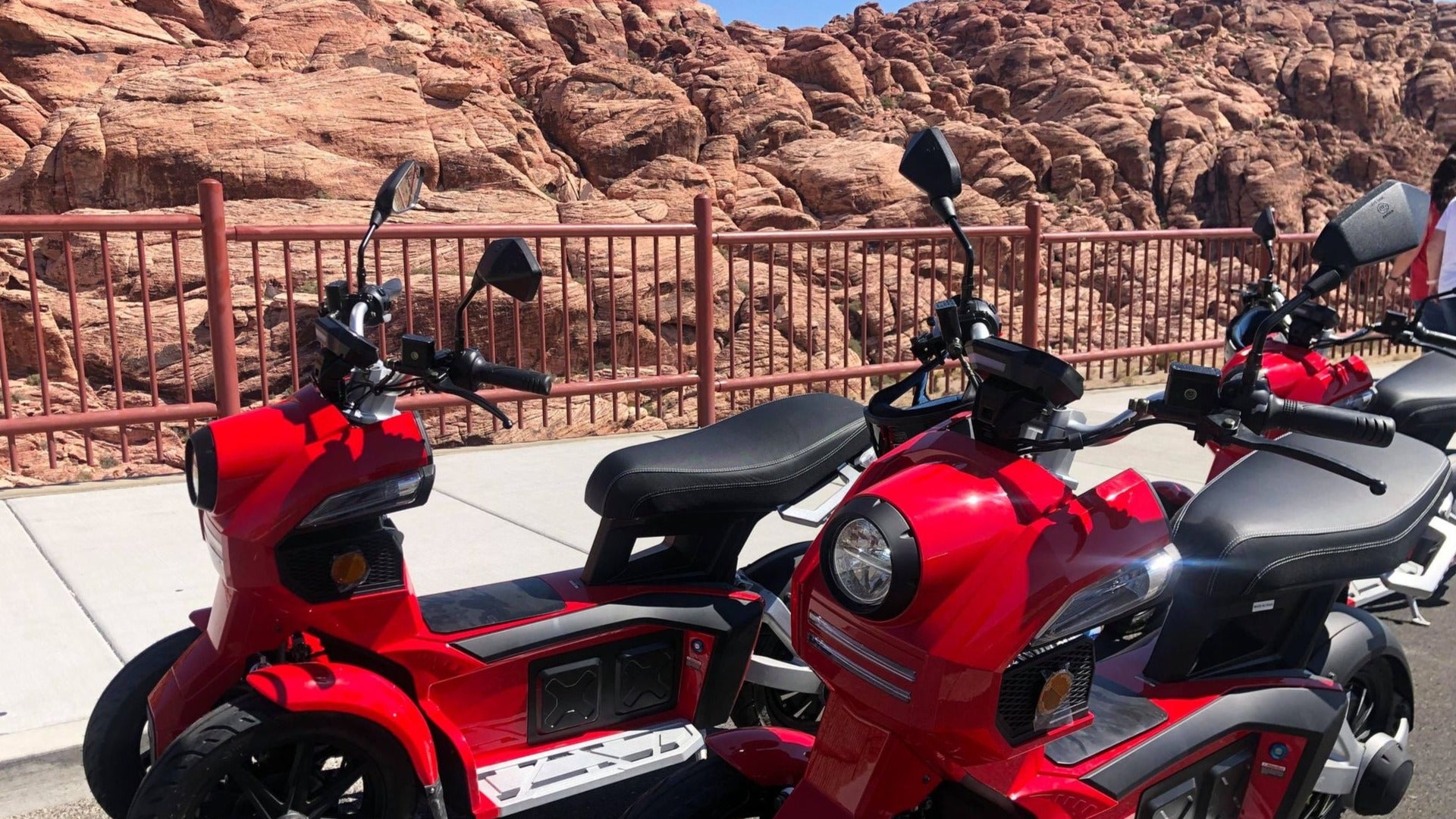 red scooters with the red rocks at the background