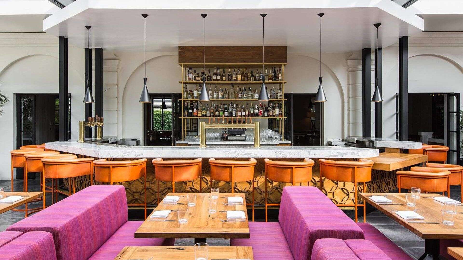 dining booth and bar with stools, alcohol at the back