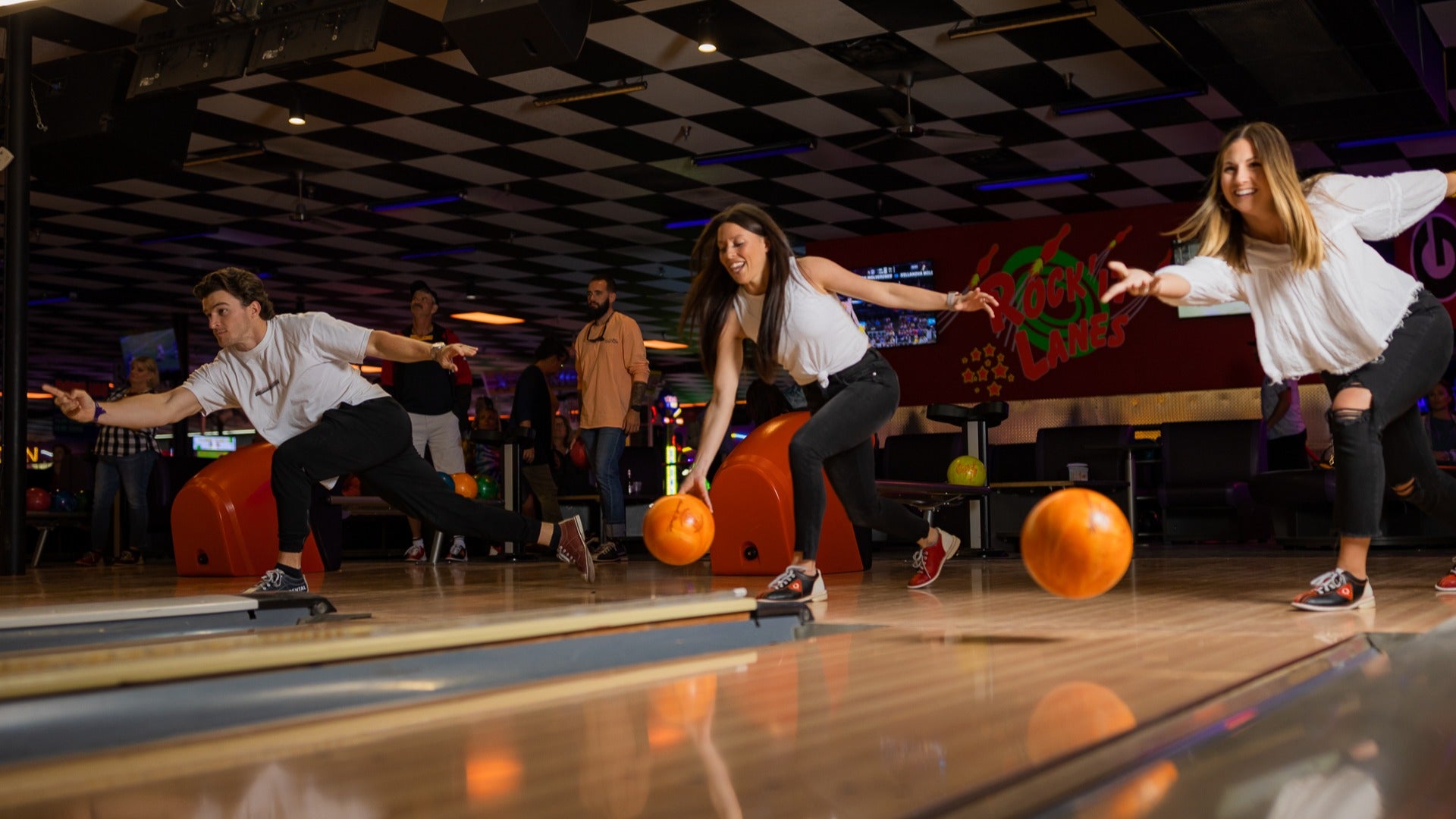 people bowling in a bowling alley