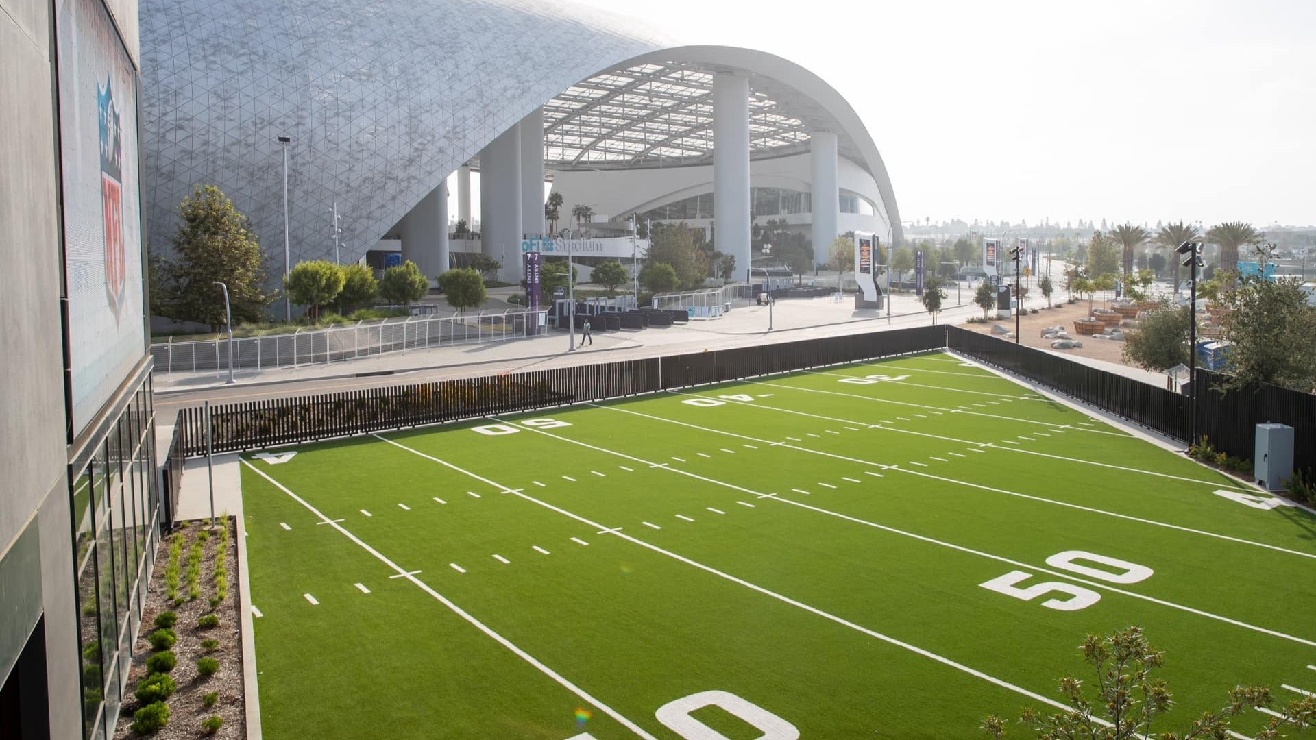 football stadium with trees at the back and arena