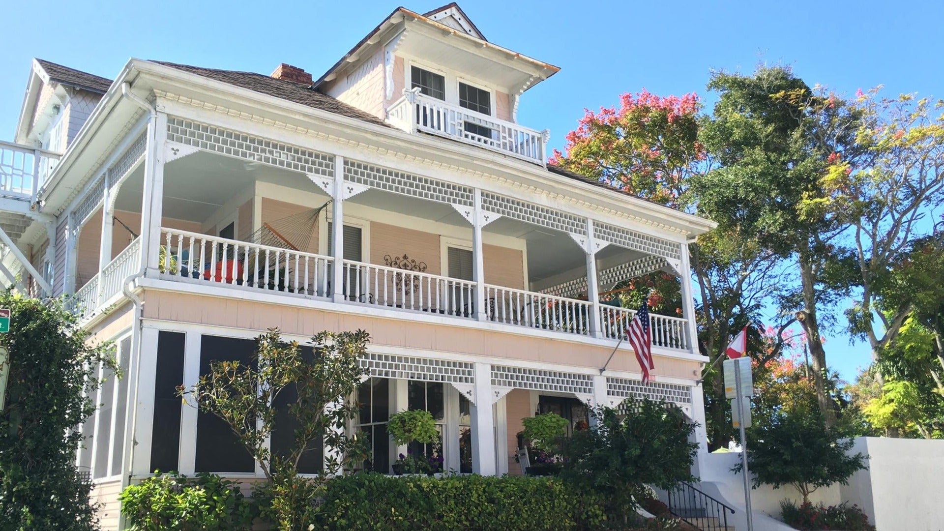 hotel exterior with trees and flags in front