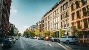 Downtown street lined with old buildings and cars