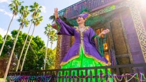 woman in costume holding beads for mardi gras