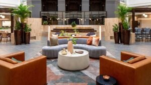 hotel lobby with couches, chairs, lights, and plants