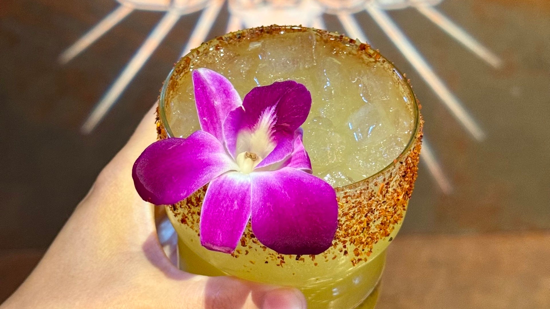 cocktail in a glass with a pink flower