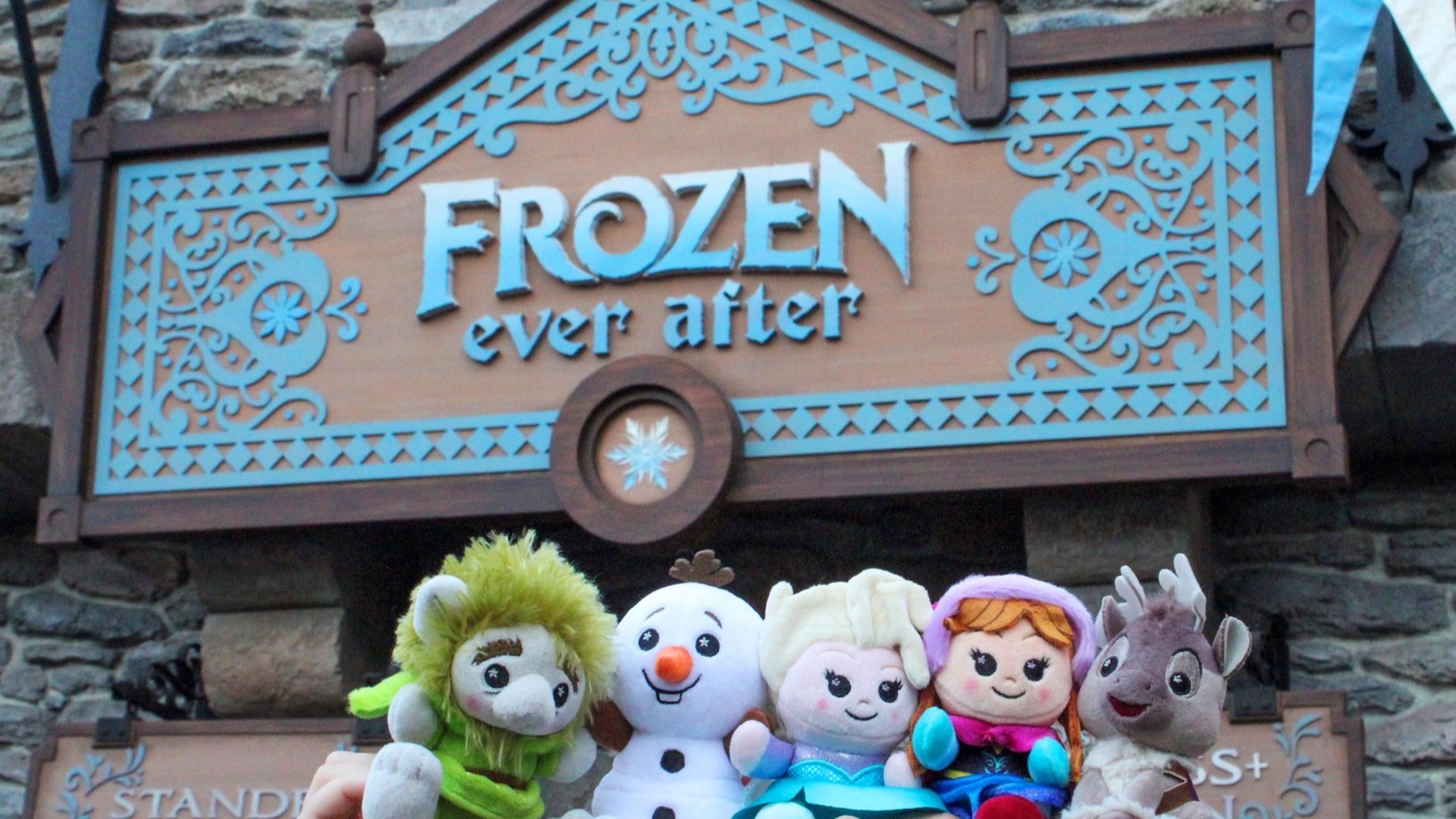 signage of frozen ever after with plushies in front