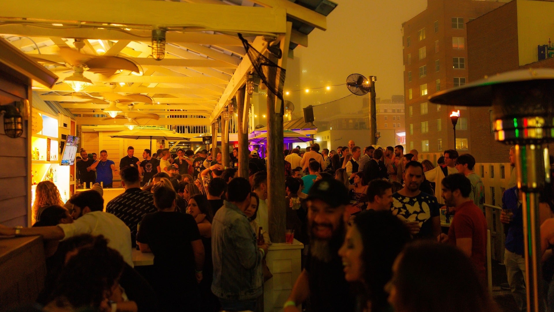 group of people in a rooftop bar